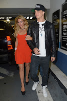 Paris Hilton and boyfrined at a parking lot