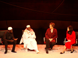 Abdoulie (far left) speaking on stage