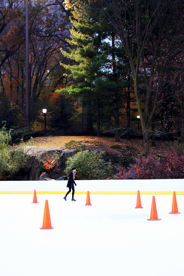 Ice skating in Central Park in fall. Fashion Blogger outfit with a beret.