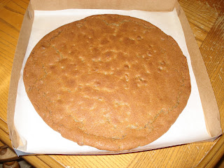 Place cooled cookie in pizza box.