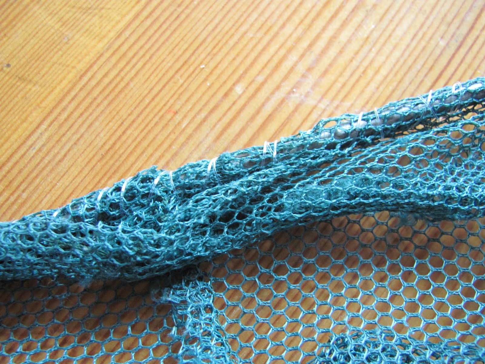 Sewn Edges A torn fishing net is partially repaired after being sewn up with fishing line in Dublin, Ireland