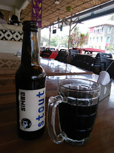 Having a drink of  " Stout " along with Francis Dmello at his residence at " Punjabi kitchen " .