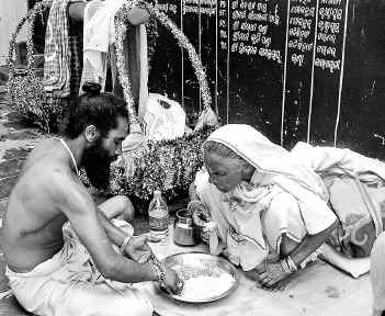 TENDER TOUCH : Kailash Giri and his mother Kirti Devi  taking lunch in a temple at Kanisi near Berhampur.