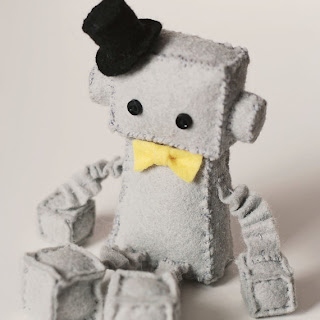 robot plush with top hat and bow tie