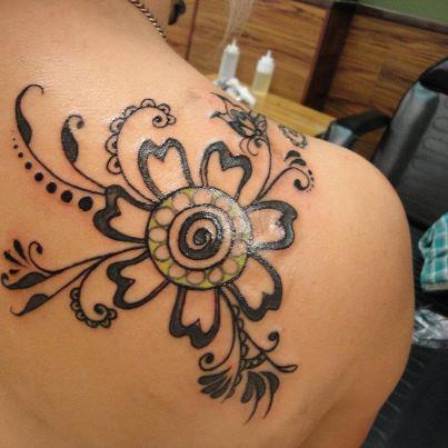 Circle flower tattoo on shoulder
