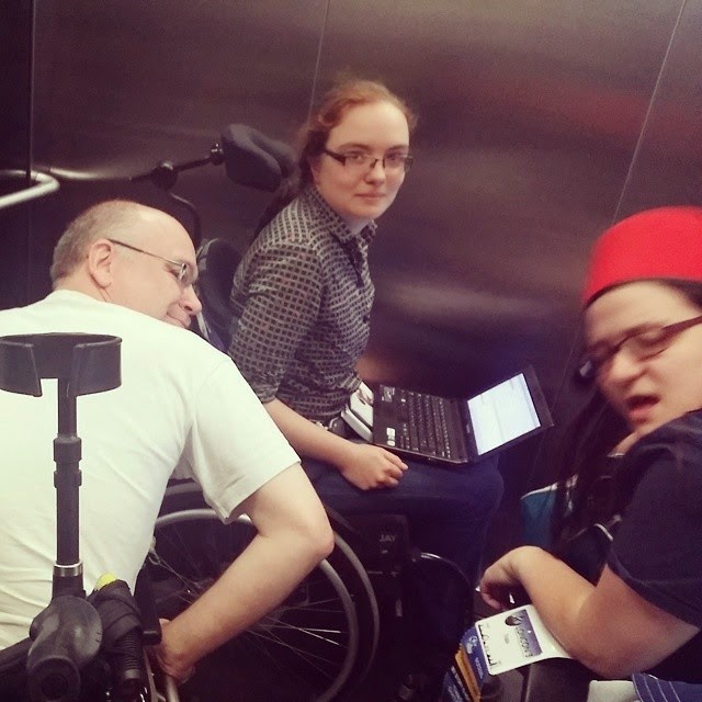 Three wheelchair users in one elevator, author on left, Kaberett at back, Trialia to right