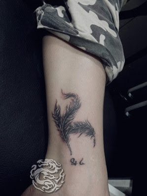 feather tattoo on the ankle