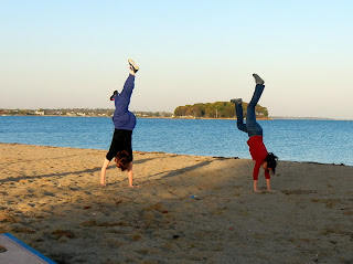 My friends trying to perfect the handstand on the beach in Norwalk, cT