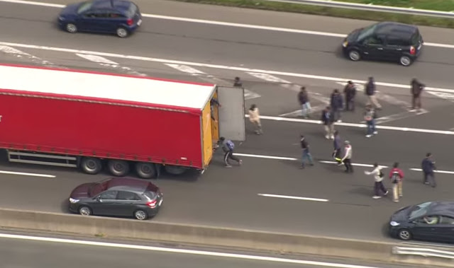 Calais migrants breaking into lorries Calais migrants breaking into lorries