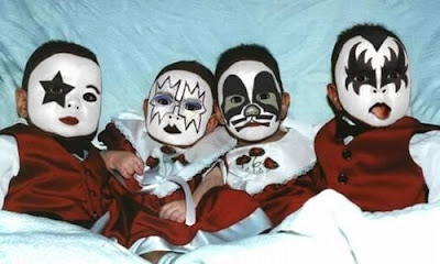 four babies dressed up like Kiss