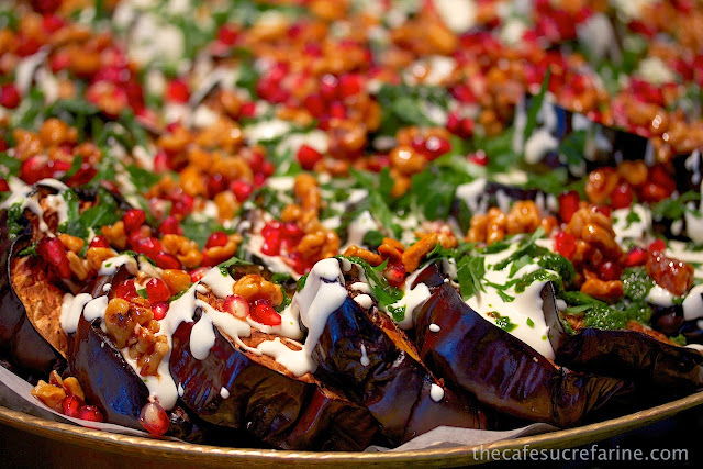 Everyday London - thecafesucrefarine.com A photo of a platter of roasted eggplant, feta, coriander pesto and walnuts on display at Nopi Restaurant in London, England.