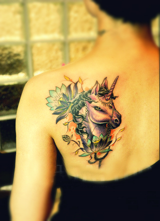 sugar unicorn tattoo on the back