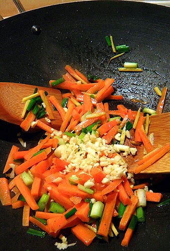 Carrots, Green Onions, Ginger, and Garlic Cooking in Wok