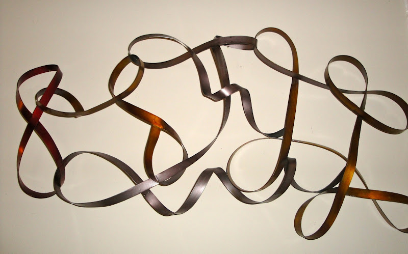 Abstract metal wall hanging via TJ Maxx ($19.99) title=