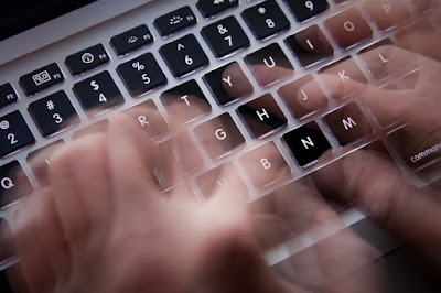 image of a keyboard with hands typing 