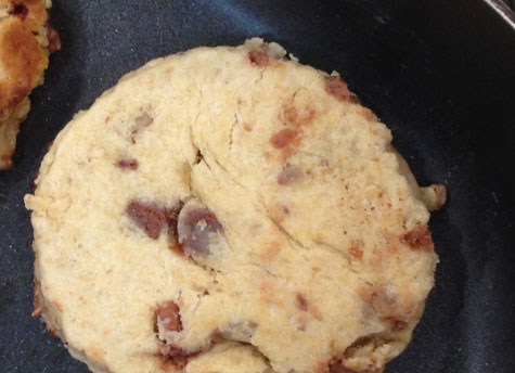Welsh cake in frying pan while cooking.