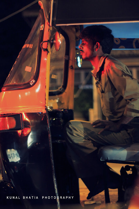 auto rickshaw tuk tuk driver in mumbai night shot man by kunal bhatia