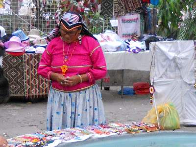 Mexican lady making a colourful necklace with seed beads