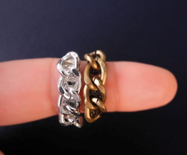 While browsing important web sites the other day, I stumbled upon some pictures of Gwen Stefani and fell in love with a curb chain ring she had on. Long story short I decided to make my own version and recycle some broken rings while at it.Now, if you can handle a torch and silver you can make a similar version with silver curb chain and some solder. If not then this is a much better way for you to create this style.  A very cute project and quite easy too!  You will need:  -  plain rings (I used some broken adjustable rings I had laying around)  - curb chain (best if the width is the same or larger than the rings)  - E6000 glue  - pliers  - toothpick and an old ring box cushion or a piece of styrofoam  You can use brand new or recycle old rings. I used some broken (their decorations had come off) adjustable ring bases. Since the chain will decorate them don't worry if there is any discoloration or chipping etc.   Start by wearing the ring you will use. Place a piece of the curb chain on it and count the links you need to use to cover the ring's surface. Use your pliers to open and detach the links needed from the rest of the chain.  Continue by placing your ring on a piece of styrofoam or an old ring box cushion to keep it stable while working on it.  Apply a little amount of glue on the toothpick and spread it along the top of the ring. Carefully put the chain links over the glue on the surface of the ring. Align the chain along the ring and apply a bit of pressure on it for a few seconds.  Let it dry for a while and you are done! You can use different metals such as bronze, copper etc. I made this in silver, bronze and neon pink by applying some nail polish on the chain.  Mix it up and enjoy! Hope you like it :)  xoxo