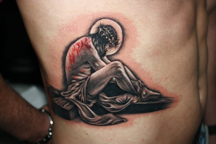 Jesus sitting on the cross lower ribs tattoo Like David Beckham tattoo