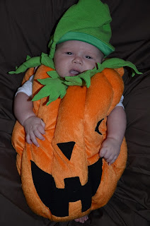 Baby in a pumpkin costume 