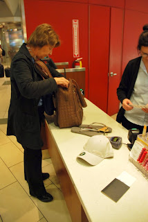 Grandmother and I making the first purchases of the trip, a pair of sandals for herself and a hat for me. We haven't even left the country yet and already we're gaining new items.