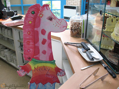 Necky Becky a Nextra-terrestrial Visitor at Durham Botanic Garden Cafe wants cake The Neckmanns of Giraffe World Storytelling by North East Artist Ingrid Sylvestre at University of Durham Botanic Garden featuring her characters the Neckmanns in their World Artwork and Stories by Ingrid Sylvestre UK Artist & Writer County Durham Newcastle upon Tyne Sunderland Tyne and Wear Middlesbrough Cleveland Teesside Northumberland Yorkshire Necky Becky a Nextra-terrestrial Visitor at Durham Botanic Garden Cafe wants cake The Neckmanns of Giraffe World Storytelling by North East Artist Ingrid Sylvestre at University of Durham Botanic Garden featuring her characters the Neckmanns in their World Artwork and Stories by Ingrid Sylvestre UK Artist & Writer County Durham Newcastle upon Tyne Sunderland Tyne and Wear Middlesbrough Cleveland Teesside Northumberland Yorkshire