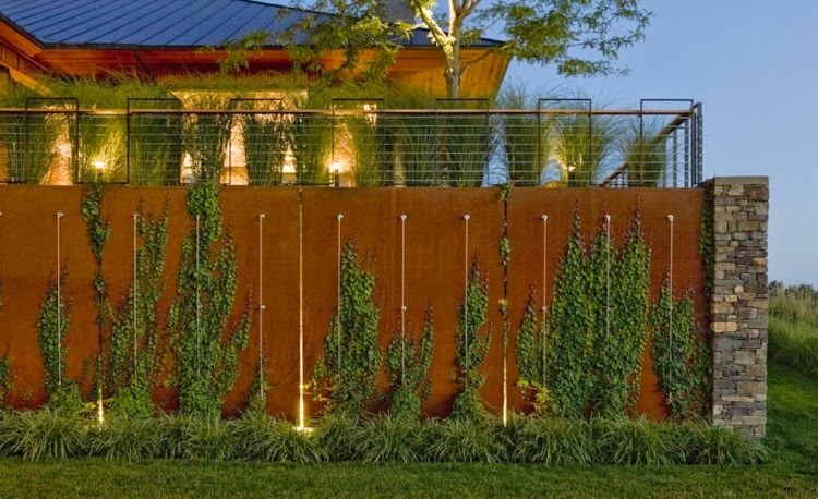 A beautiful garden fence panels with a climbing plants on it.