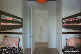 Bunk room with a navy ceiling and orange drum shade