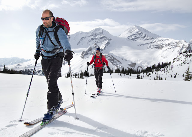 Two skiers skin across Little Yoho Valley with The President and Vice President in the background.