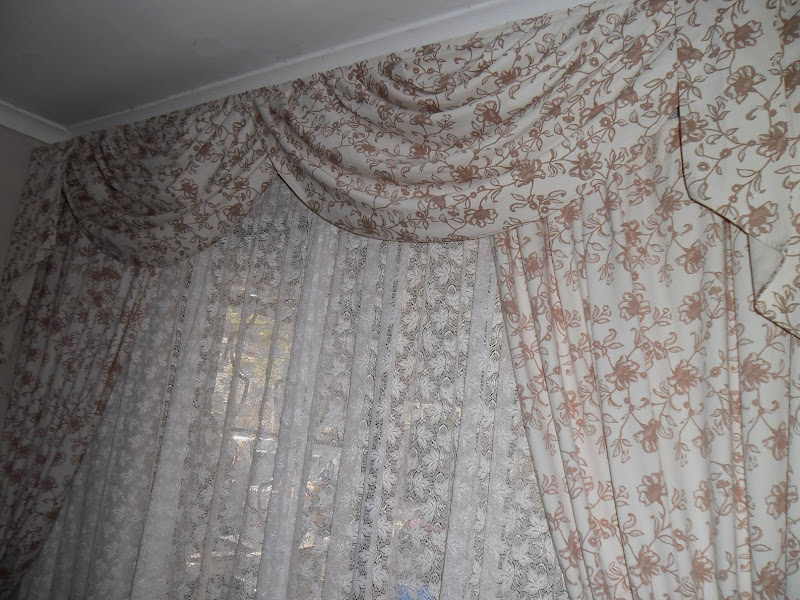 Cream/brown floral lounge curtains, swags and tails. title=