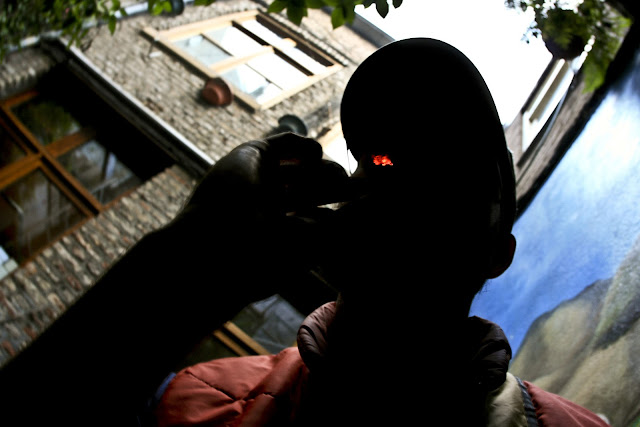 A guy smoking a huge joint on the back porch at Cafe 69 in Maastricht, Holland.