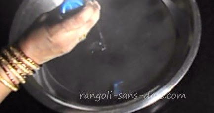 add the oil on the clean plate and spread the oil rangoli-in-water-step-1.jpg