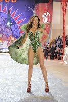 Miranda Kerr on the runway in a skimpy green outfit