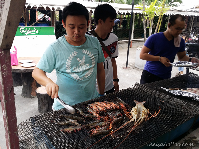 Cooking seafood on BBQ pit at Tropicana Ebi Fishing