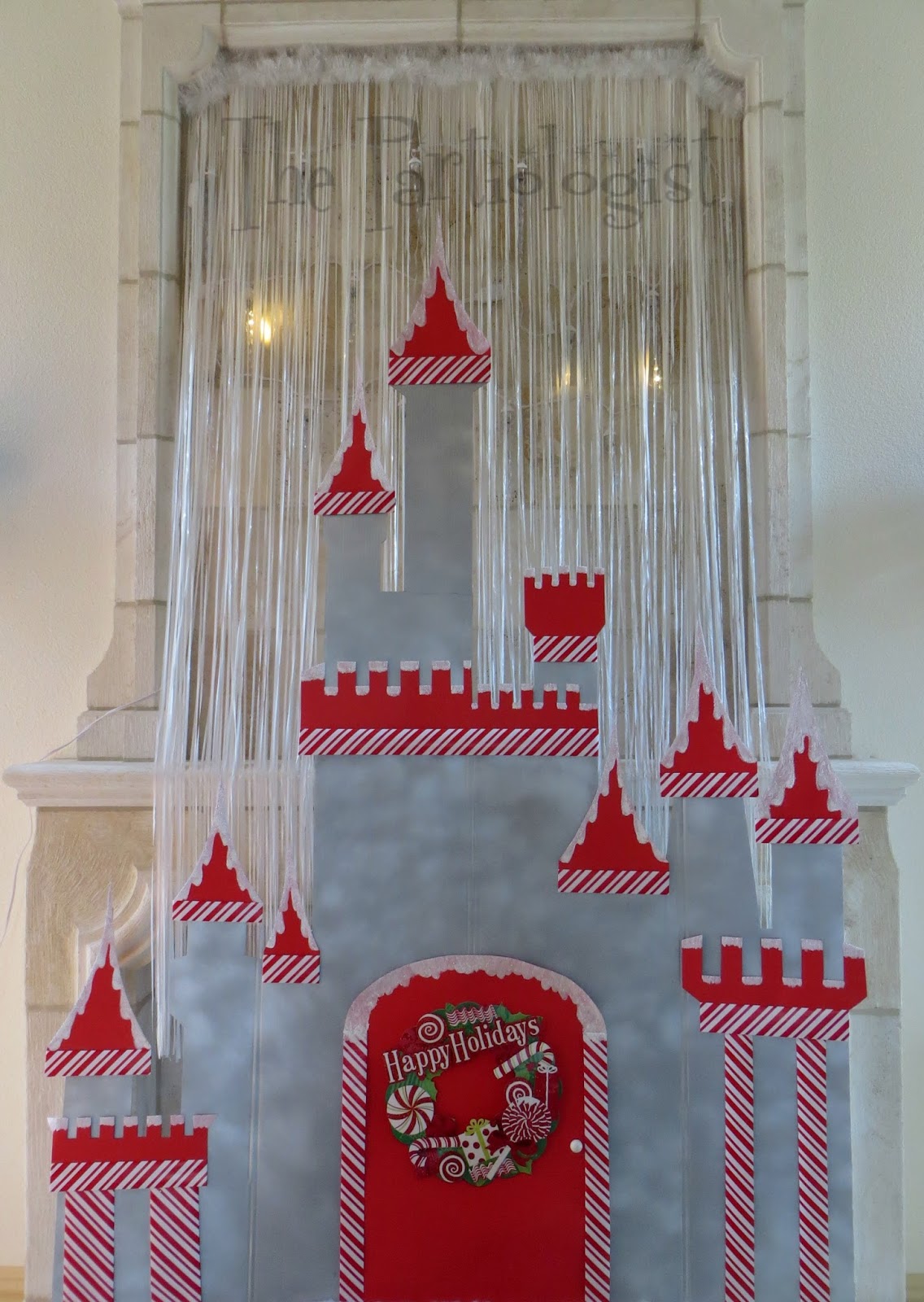behind the castle i hung dripping icicle lights to resemble snow falling behind the castle i covered the cord with a white plastic door banner and topped