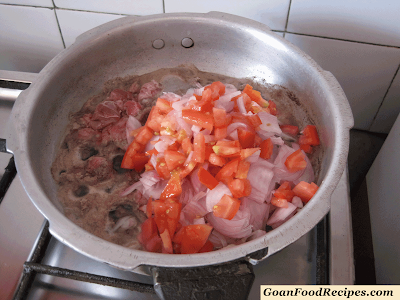 add chopped tomato onions to beef
