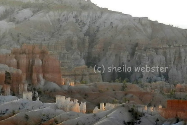 a close-up of white hoodoos in the distance