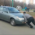 A strong guy stops a car by bare hands (Video)