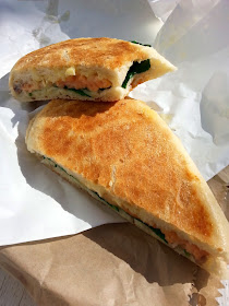 Toasted panini with salmon, brie and spinach.