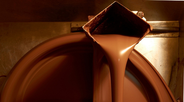 Liquid chocolate pouring out of a machine