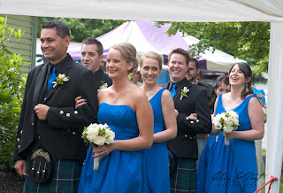Men in kilts and ladies in blue - lined up to begin Megan and Colin's wedding Groomsmen and bridesmaids ready to enter Colin and Megan's wedding