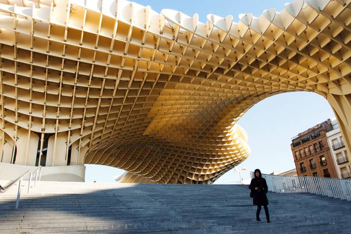 Metropol Parasol is a wooden structure located at La Encarnación square, in the old quarter of Seville, Spain. Designed by German architect Jürgen Mayer-Hermann, the structure resembles a grove of prefabricated wooden trees soaring 26 meters into the air. It has dimensions of 150 by 70 metres and claims to be the largest wooden structure in the world. 