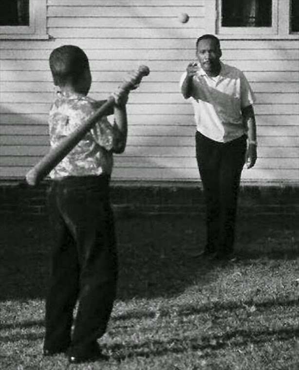 Martin Luther King Jr. at home playing baseball with his son.