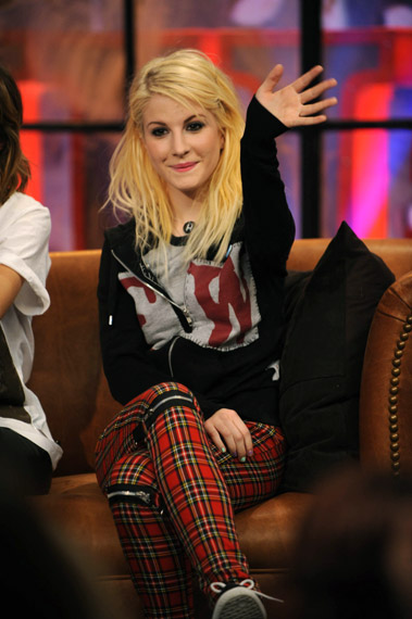Hayley Williams wearing a black sweater and plaid pants in a tv appearance