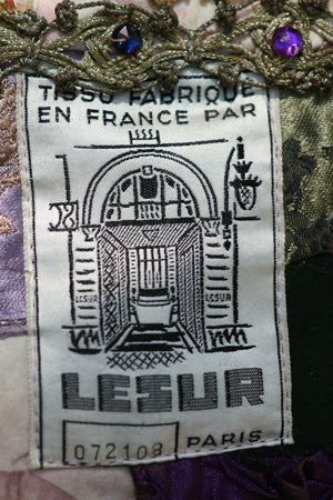 Antique French label with vintage metallic trim and rhinestones.