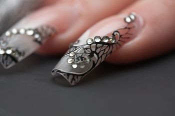  Long Nails Accented with Stones and Black Stripes