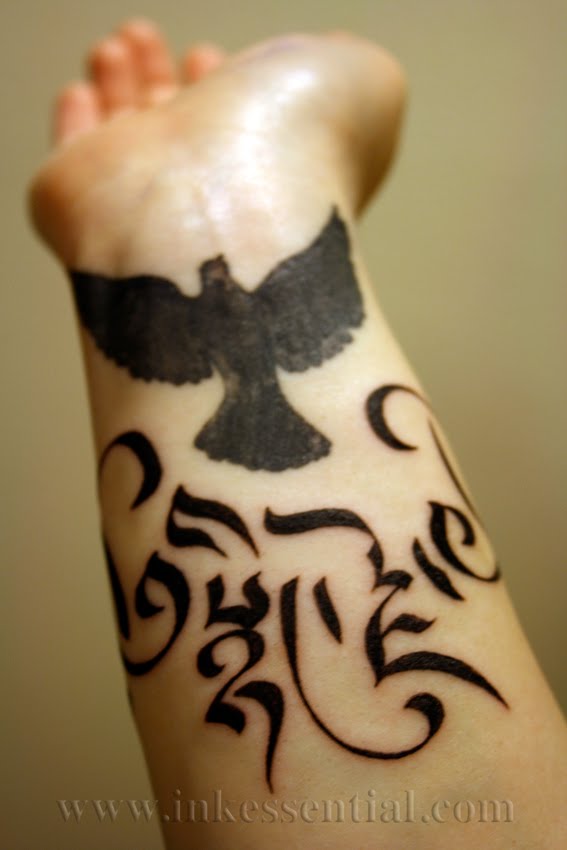  Compassion in an ornamented Drutsa script wraps an existing dove tattoo.