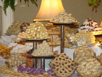 At wedding receptions in addition to wedding cake a table is loaded up 