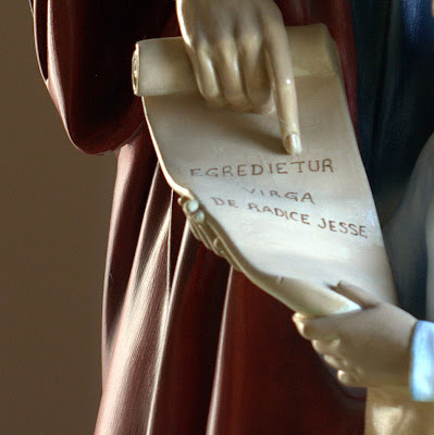 Close up picture of scroll with Latin inscription Egredietur virga de radice Jesse.